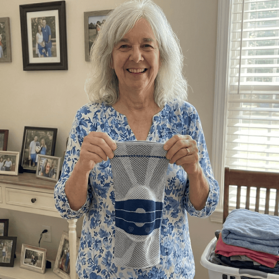Carol holding her Necs Knee Sleeve